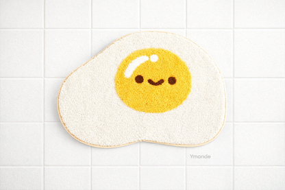 Soft egg-shaped bath mat with non-slip microfiber and playful design from Ymonde
